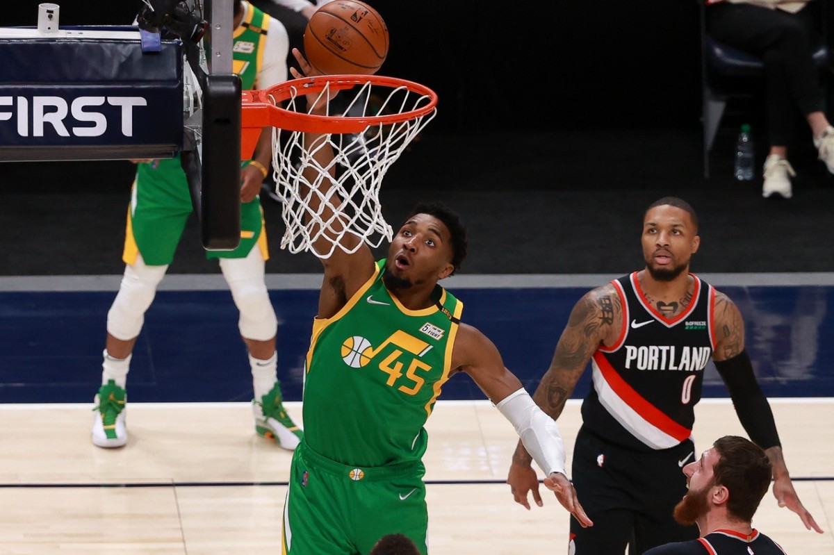 Donovan Mitchell (45) scores two points over Damian Lillard (0) and the Portland Trail Blazers